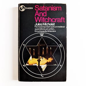 May include: A vintage paperback book titled "Satanism And Witchcraft" by Jules Michelet. The cover is black with pink and white text and a white pentagram design. The book is a historical work on medieval superstitions.