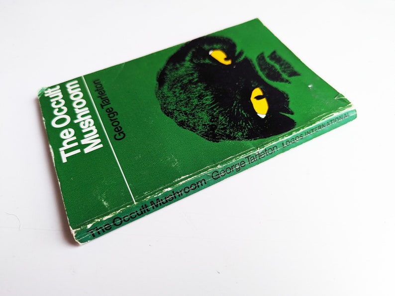 May include: A green paperback book titled "The Occult Mushroom" by George Tarleton. The cover features a black and white illustration of a mushroom with yellow eyes.
