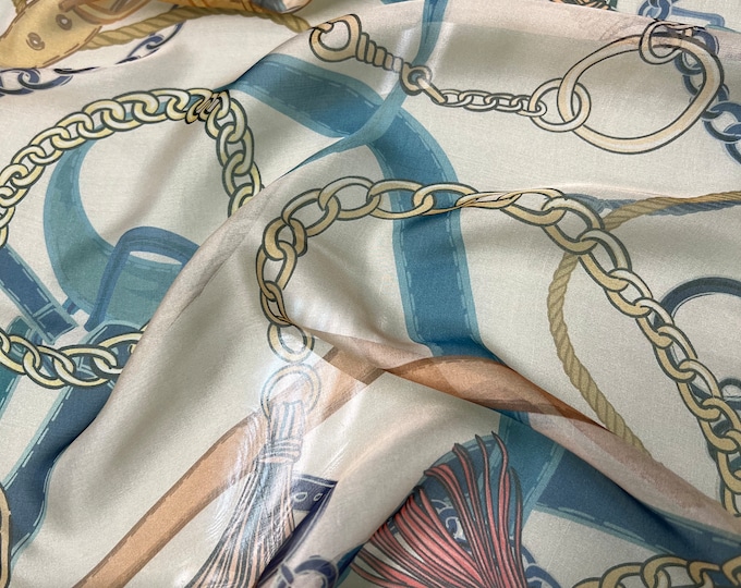 100% silk satin face chiffon digital print 54" wide    Beautiful champagne base with turquoise tan and gold belt chain style design