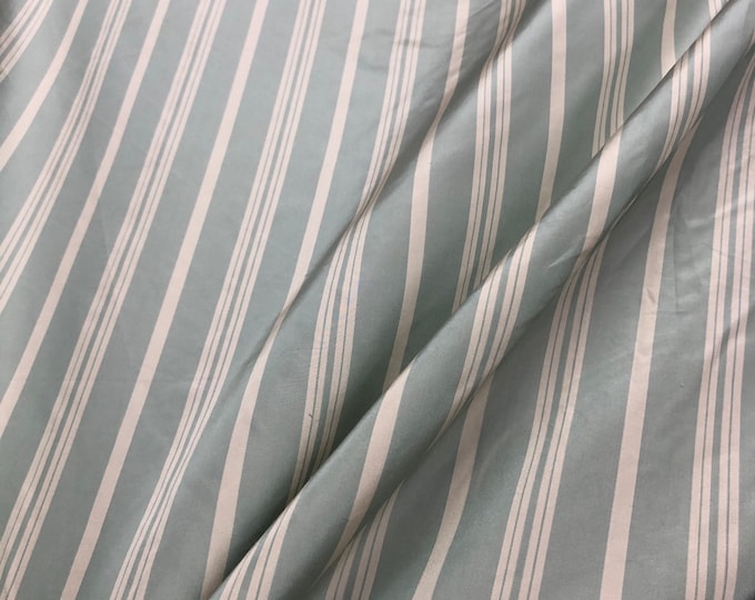 Beautiful aqua ivory silk taffeta stripe 54” wide. Best used for home decor and apareal. Sold by the yard