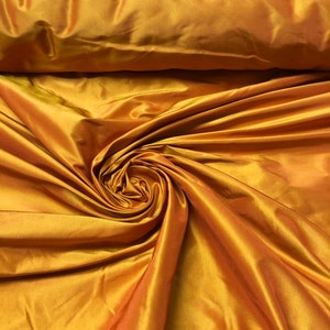 Beautiful orange gold heavy silk taffeta 54” wide best use soft apparel and home decor. Sold by the yard.