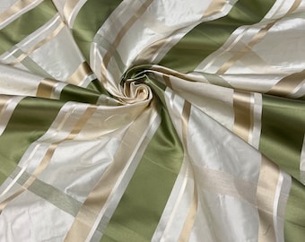 100% silk beautiful ivory base with olive sage green with ivory satin stripe plaids .  silk taffeta 54" wide            Sold by the yard