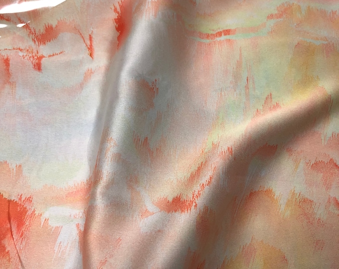 Beautiful pale yellow orange shades abstract design digital print on silky satin 54” wide. Sold by the yard. Best used for apparel