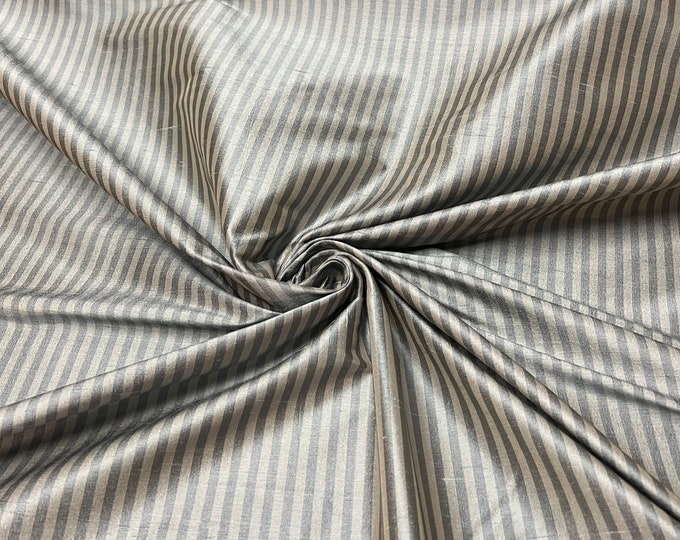 Beautiful 100 % silk shantung tan and beige tiny stripe 54” wide.  Best used for apparel and home Decore.  Sold by the yard
