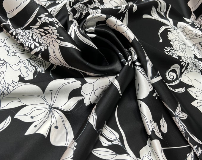 100% silk satin charmeuse digital print 54" wide    Beautiful black base with white ivory color flowers design soft fabric 54” wide
