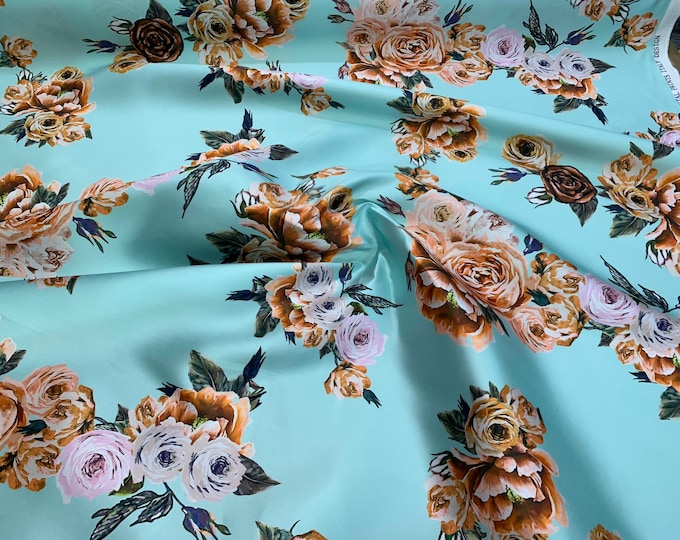 Mikado Zibelline printed fabric 54” wide.  Beautiful aqua base floral color print beat used for apparel. Sold by the yard