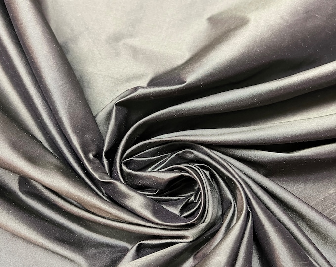 Beautiful charcoal Greenish Gray Irredescent 100% silk taffeta 54” wide.  Best used for apparel and home Decore.  Sold by the yard