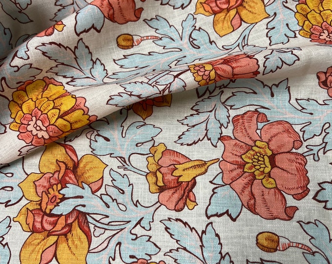 100% Linen designer print, Ivory base with burnt orange yellow baby blue floral  designer printed linen. 58” wide Sold by the yard