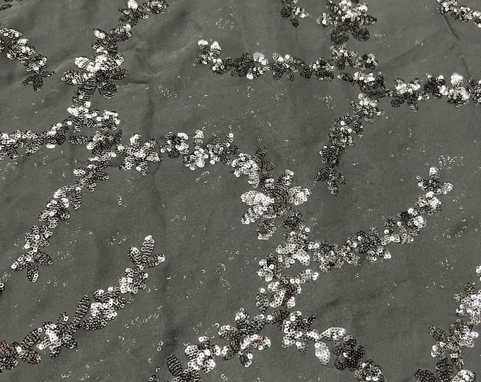 Beautiful black on black georgette sequin emb 46”wide    Beautiful artistic design sequenced viscose soft chiffon.