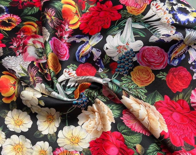 Mikado Zibelline printed fabric 54” wide.  Beautiful black base multi color mix flowers red yellow etc used for apparel.  Sold by the yard