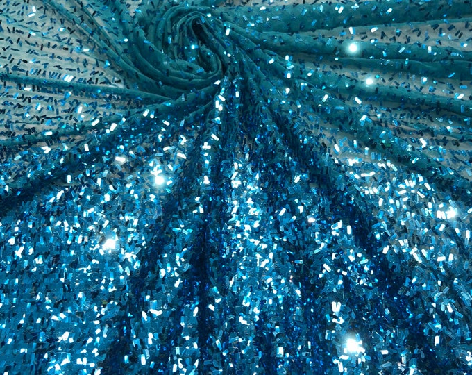 Sequin on tule 58" wide   Beautiful turquise color border style sequin fabric sold by the yard