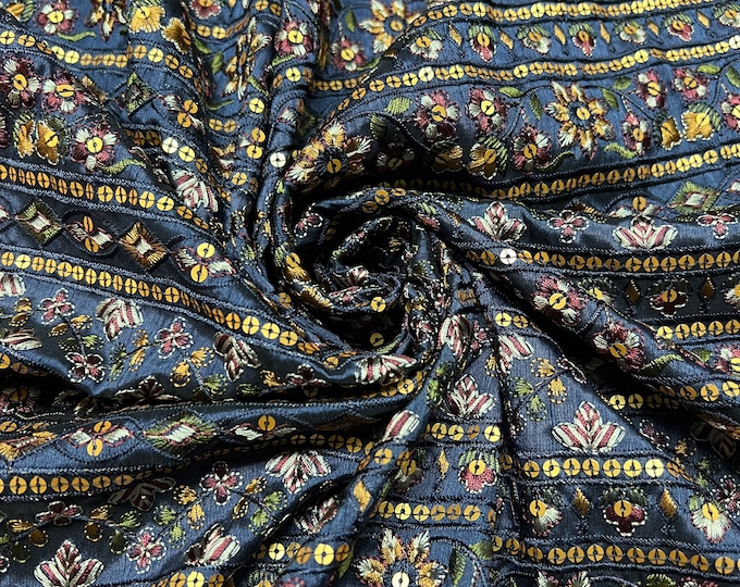 Beautiful navy blue base multi color stripe style sequence thread embroidered Shantung 45” wide. Best used for home decor. Sold by the yard