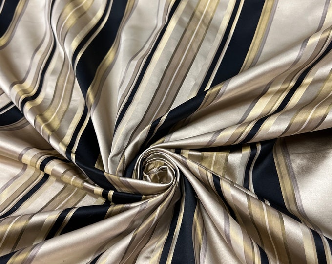 100% silk beautiful light gold tan shades with black & gold  satin stripes.  silk satin taffeta 54" wide            Sold by the yard