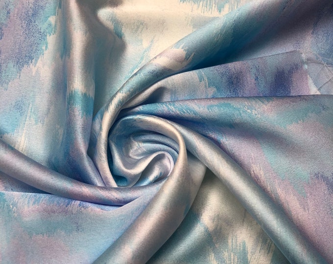 Beautiful ocean blue purple shades abstract design digital print on silky satin 54” wide. Sold by the yard. Best used for apparel