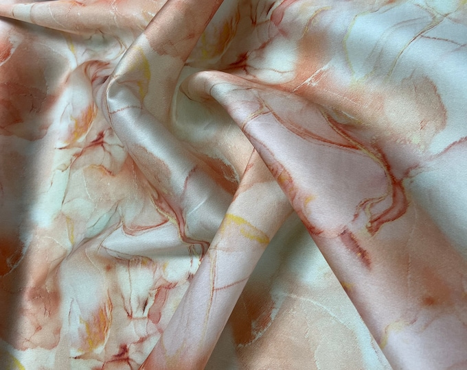 100% silk satin face organza, also called silk Gazzar 54” wide. Beautiful painting style abstract design peach ivory shades digital design.