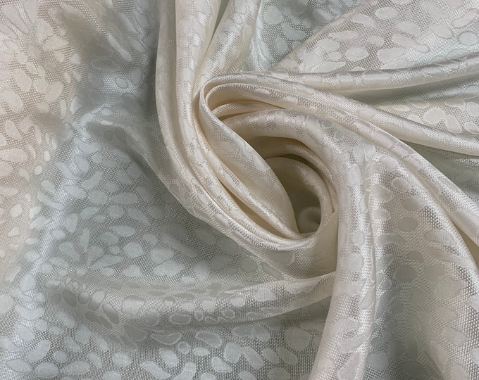 Beautiful 100% ivory jaquard silk Charmouse 45” best used for apparel.  Sold by the yard
