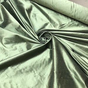 Beautiful basil green iridescent silk shantung 54” wide.  Best used for home decor sold by the yard