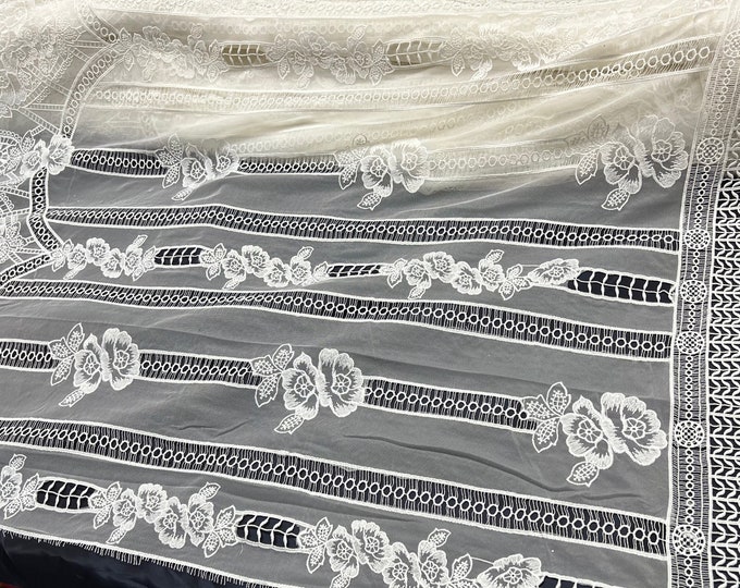 Guipure lace fabric 50” wide. Beautiful mesh base with border style floral design, natural white color.