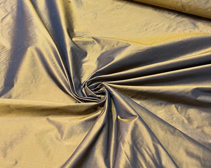 Beautiful bright gold copper Irredescent 100% silk taffeta 54” wide.  Best used for apparel and home Decore.  Sold by the yard