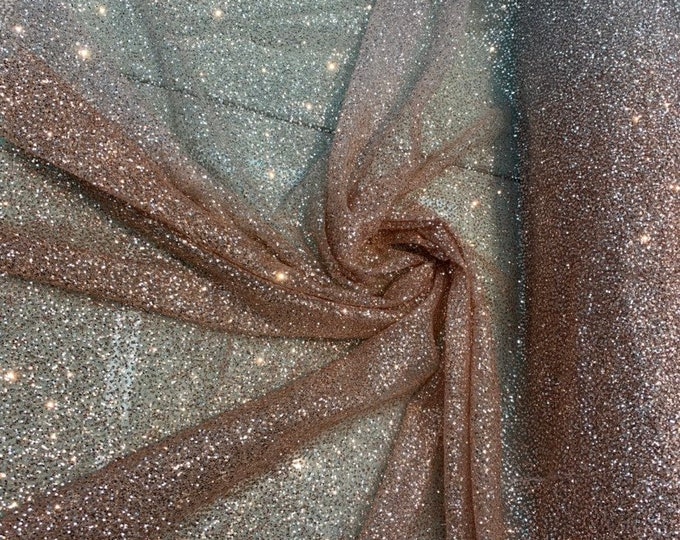 Glitter Metallic tule fabric useable for apparel, party Decore etc...& much more.  58” wide beautiful ombré pinkish gold color.