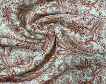 100% Linen designer print, champagne base with brown burnt orange colors paisley designer printed linen. 58” wide Sold by the yard