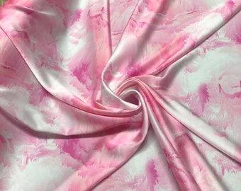 Beautiful Pink white cloud style designer print on silky satin 54” wide. Sold by the yard. Best used for apparel