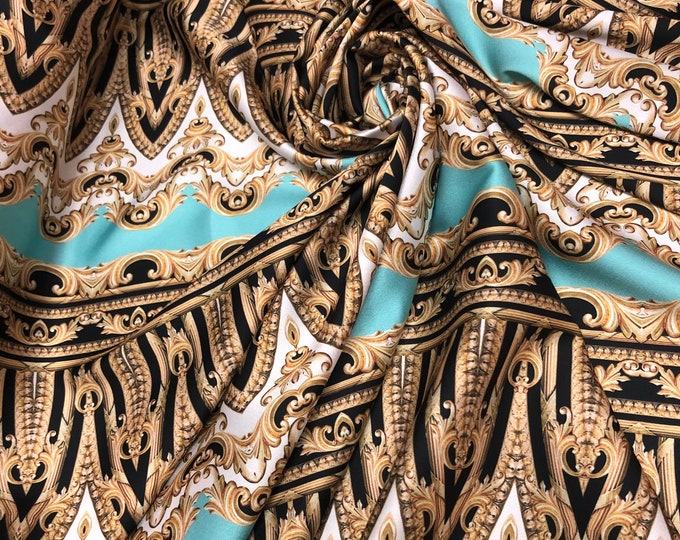 Beautiful Agua blue with gold black color designer print on silky satin 54” wide. Sold by the yard. Best used for apparel