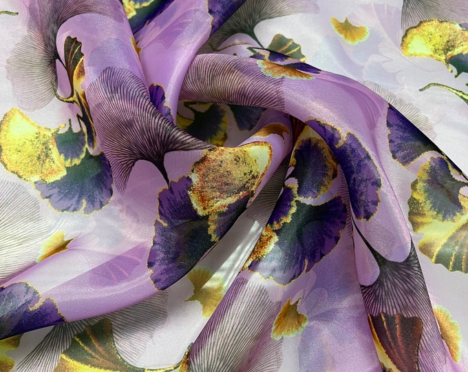 Satin face organza, also called Gazzar 54” wide. Beautiful purple lilac with yellow blue ginkgo floral summer design.