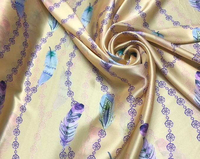 100% silk satin charmeuse digital print 54" wide    Beautiful pastel yellow with multi color feather design print  silky soft fabric