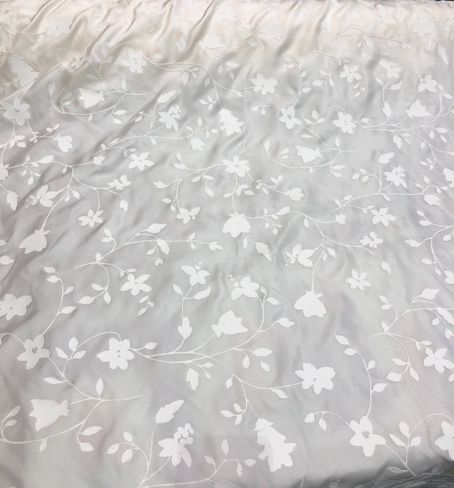 100 silk 58 wide Ivory silk with embosed ivory flowers on the fabric