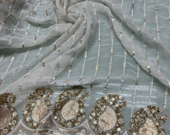 Beautiful ivory base with matte gold border embroidery sequined chiffon 52”wide    Beautiful border style striped sequin vescose chiffon.