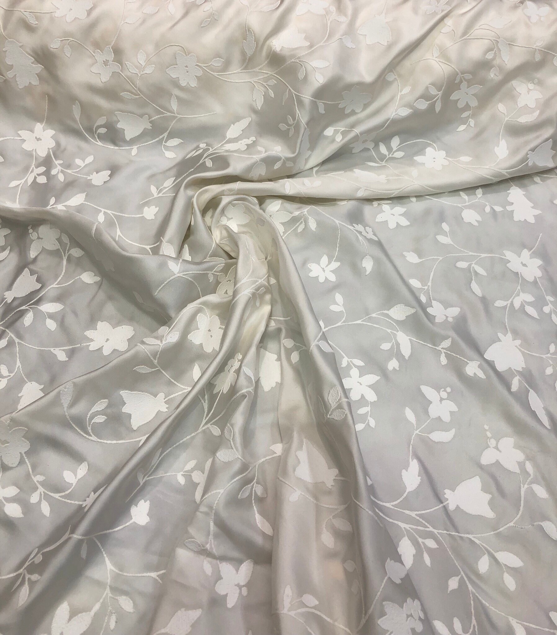 100 silk 58 wide Ivory silk with embosed ivory flowers on the fabric