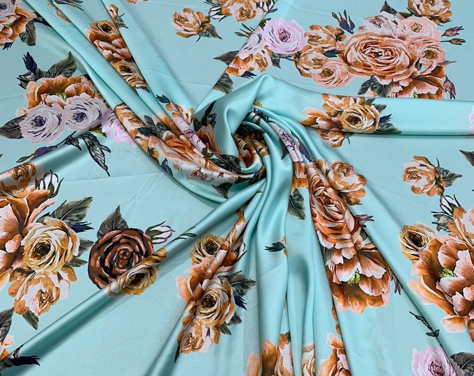 Digital printed satin Charmouse 54” wide. Beautiful aqua base floral print beat used for apparel. Sold by the yard