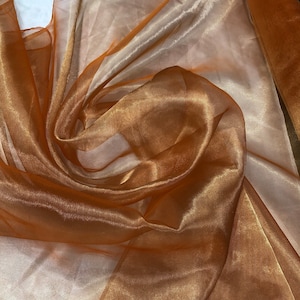 Metallic orange gold  color  100% Silk Organza 45&quot; wide. Usable for Apparel and interior designing.