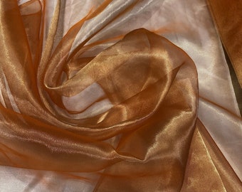 Metallic orange gold  color  100% Silk Organza 45" wide. Usable for Apparel and interior designing.