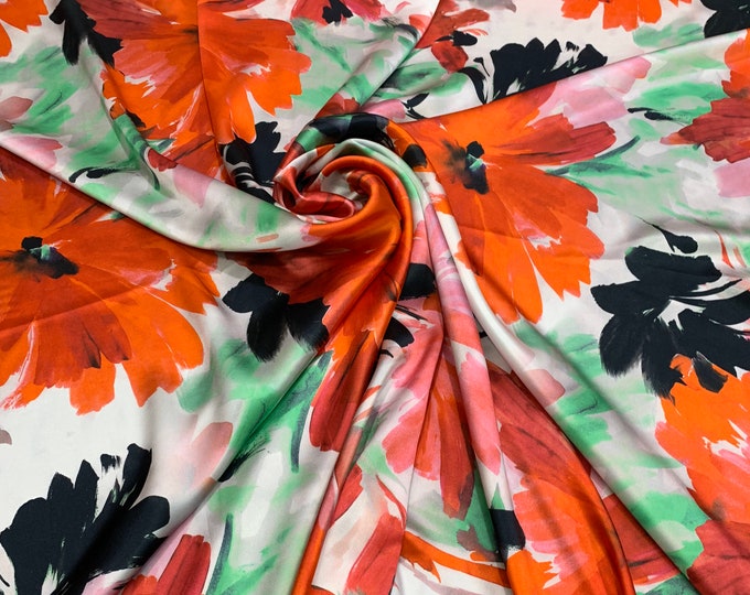 100% silk satin Charmouse 54” wide.   Beautiful red black white floral print beat used for apparel.   Sold by the yard