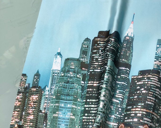 Beautiful New York city skyline view blue shades digital print on silky satin 54” wide. Sold by the yard. Best used for apparel