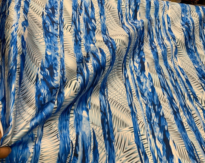 Mikado Zibelline printed fabric 54” wide.  Beautiful white blue color combination stripped abstract pattern best used for apparel.