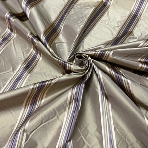 100% silk beautiful beige tan gold  with purple shades  satin stripes.  silk satin taffeta 54&quot; wide            Sold by the yard