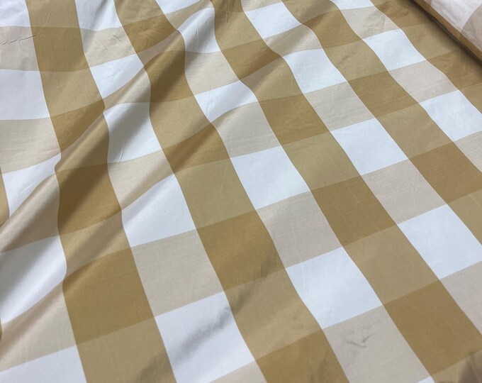 Beautiful Champagne and white taffeta plaids 54” wide.  Best used for home decor and appreal.  Sold by the yard