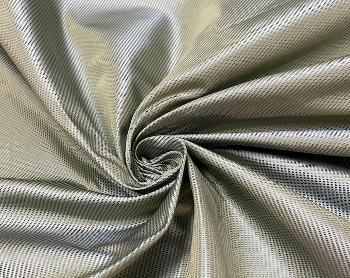 Beautiful 100 % silk taffeta Jaquard self aqua sage with gold tint silk taffeta stripe 54” wide.  Best used for apparel and home Decore.