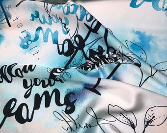 Beautiful white turquoise blue black abstract design digital print on silky satin 54” wide. Sold by the yard. Best used for apparel