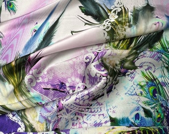 100% silk satin charmeuse digital print 54" wide    Beautiful ivory lilac base with purple & peacock feathers border style print 54” wide