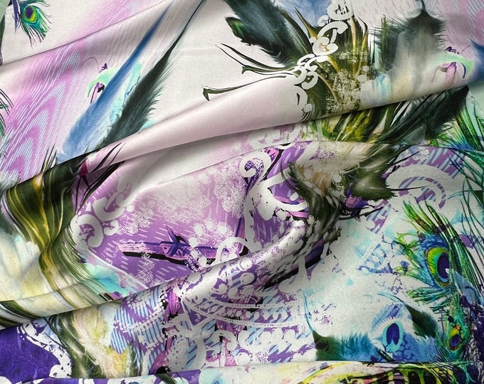 100% silk satin charmeuse digital print 54" wide    Beautiful ivory lilac base with purple & peacock feathers border style print 54” wide