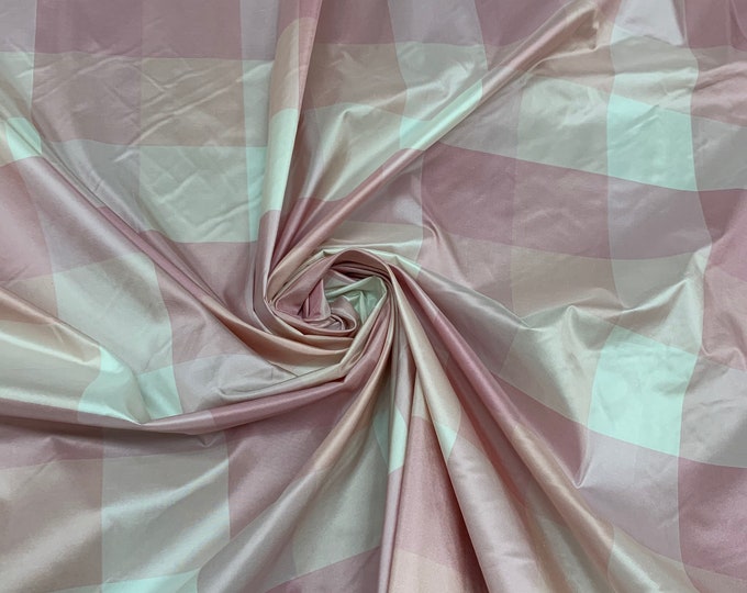 Beautiful pink white peach combination 100% silk taffeta plaids 54” wide.  Best used for apparel & home Decore. Sold by the yard
