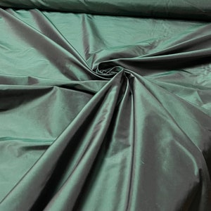 Beautiful Bottle Green Irredescent color 100% silk taffeta 54” wide.  Best used for apparel and home Decore.  Sold by the yard