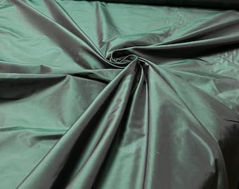 Beautiful Bottle Green Irredescent color 100% silk taffeta 54” wide.  Best used for apparel and home Decore.  Sold by the yard