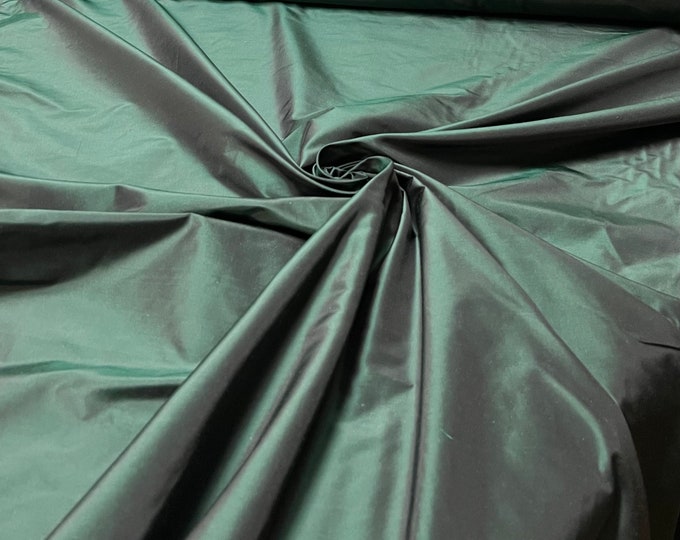 Beautiful Bottle Green Irredescent color 100% silk taffeta 54” wide.  Best used for apparel and home Decore.  Sold by the yard