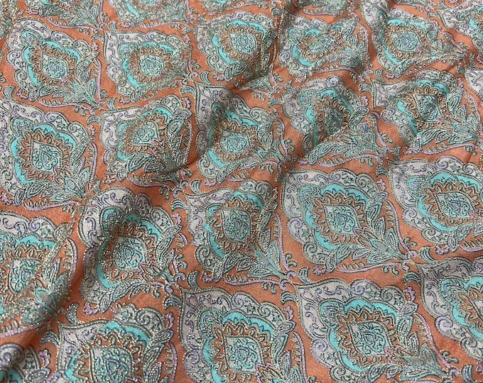 Beautiful soft orange base with green silvers emb 46”wide    Beautiful artistic design embroidered viscose soft chiffon.