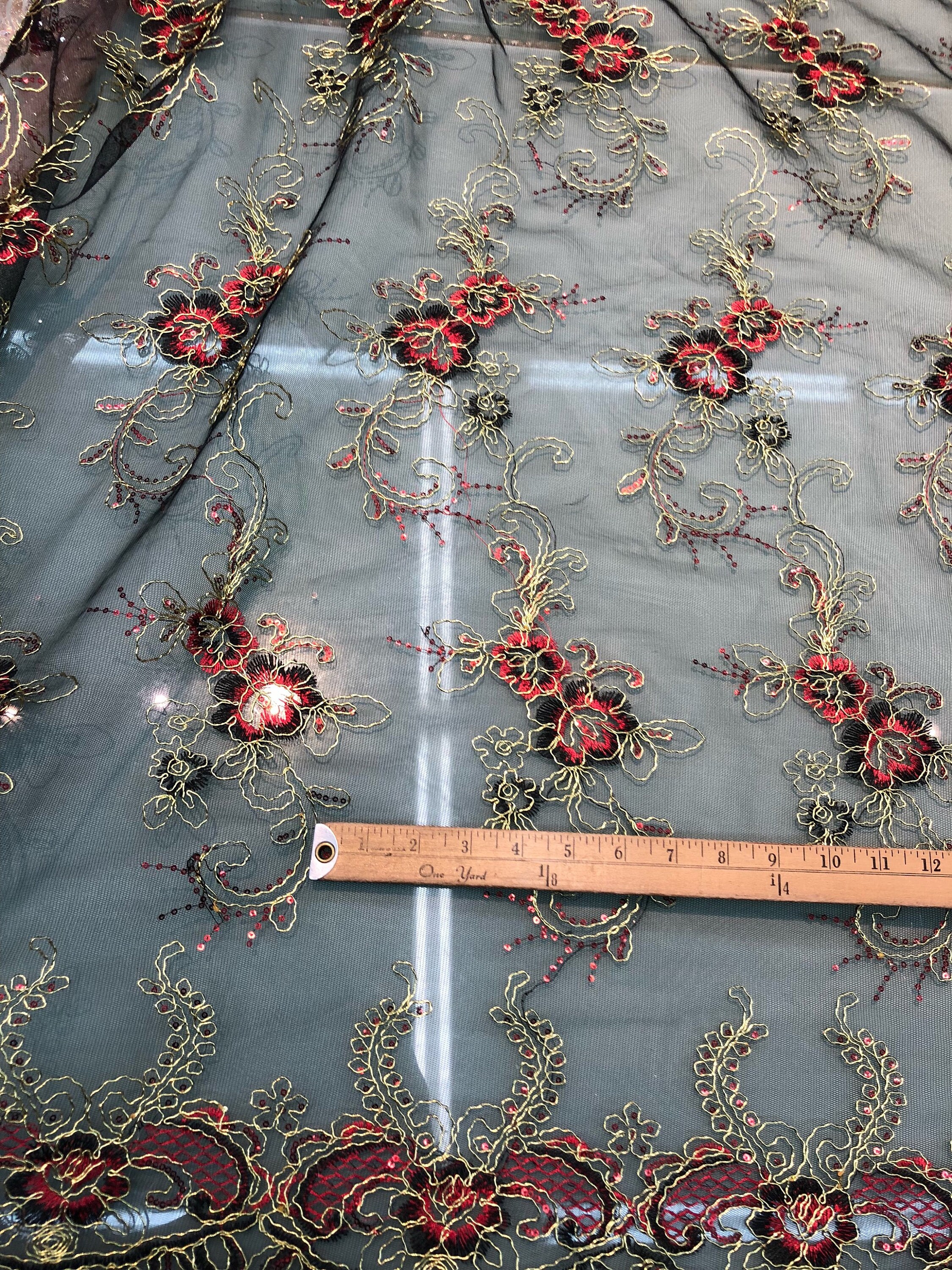 BLACK DIVA DESIGN EMBROIDERY WITH HEAVY BEADED ON A MESH-SOLD BY YARD.